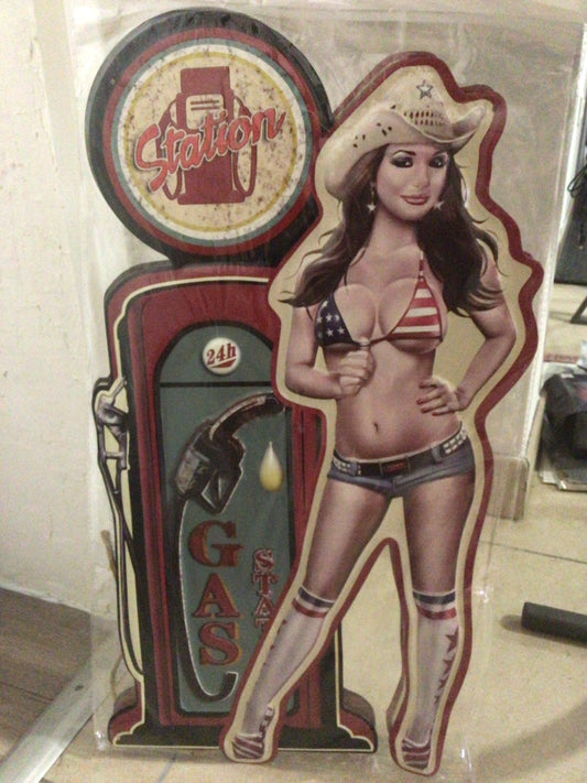 Cowgirl sign with a gas station